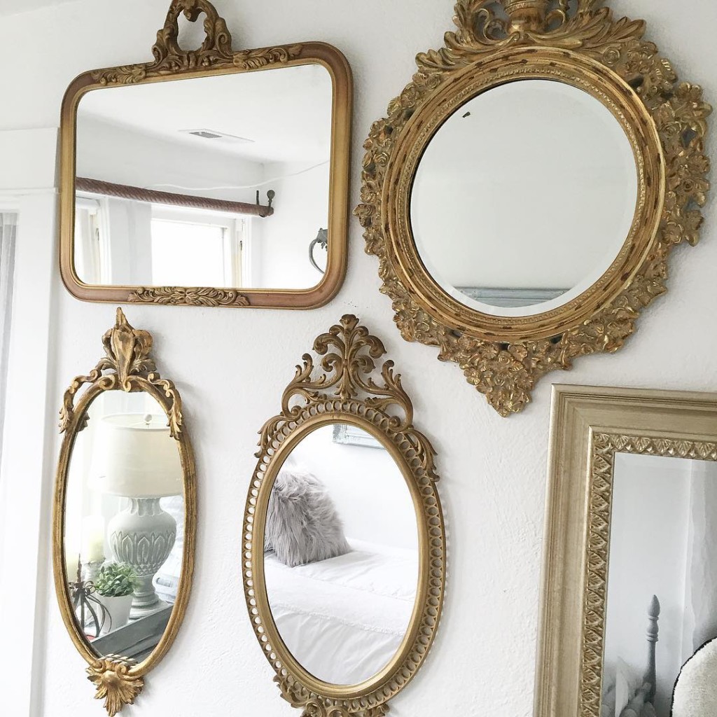 5 gold ornate mirrors creating a gallery wall