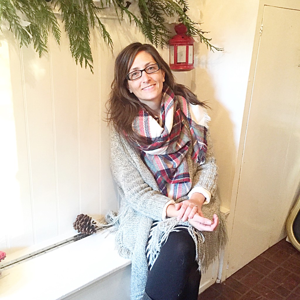 Rhonda Hallstrom Sitting in mudroom with a garland behind her