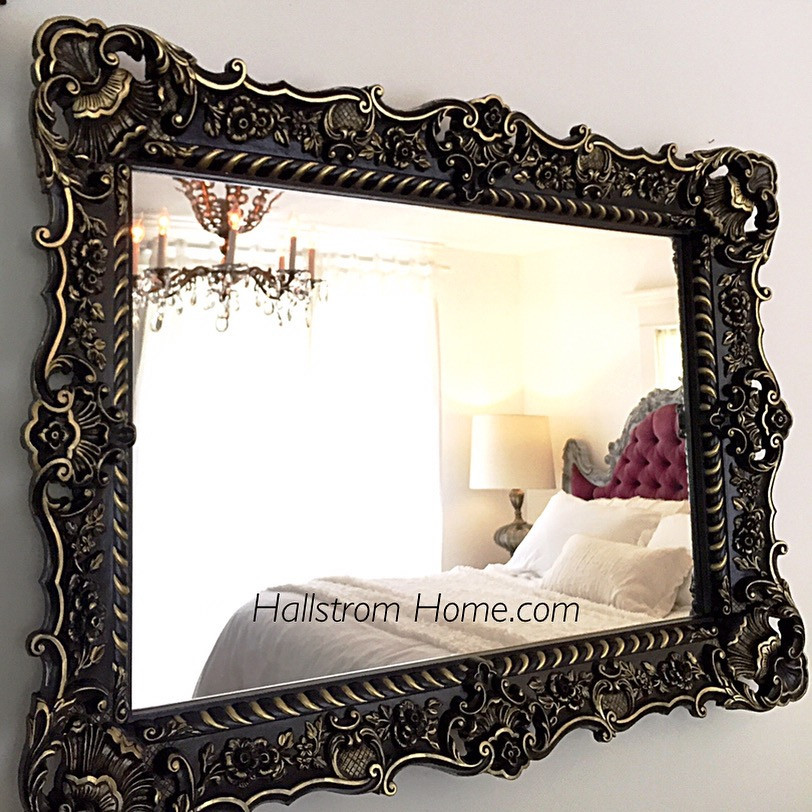 Black and Gold baroque mirror with a tufted bed in the reflection