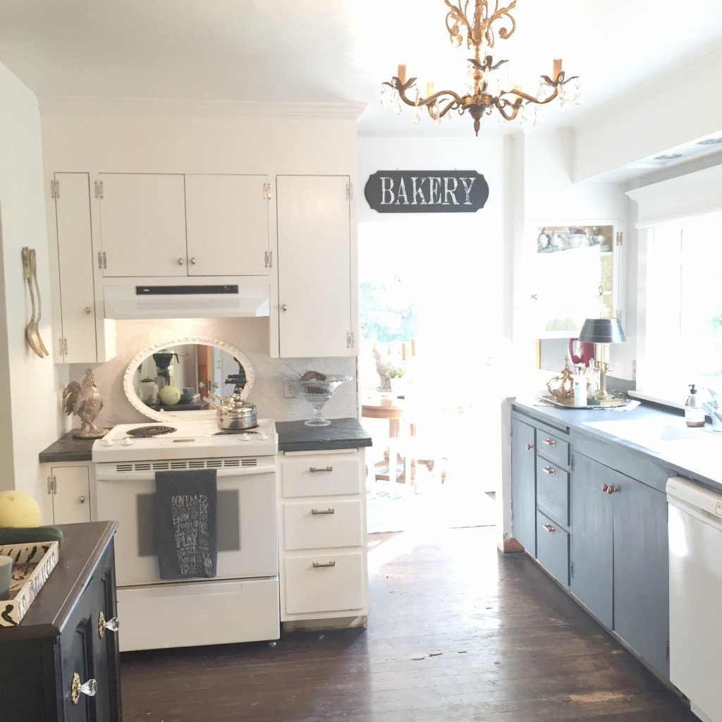 farmhouse kitchen with large bakery sign and gold chandelier