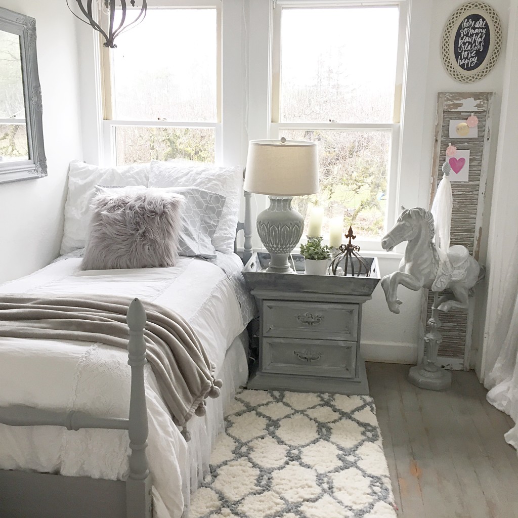 grey girls room with twin size bed and grey fur pillow and grey night stand