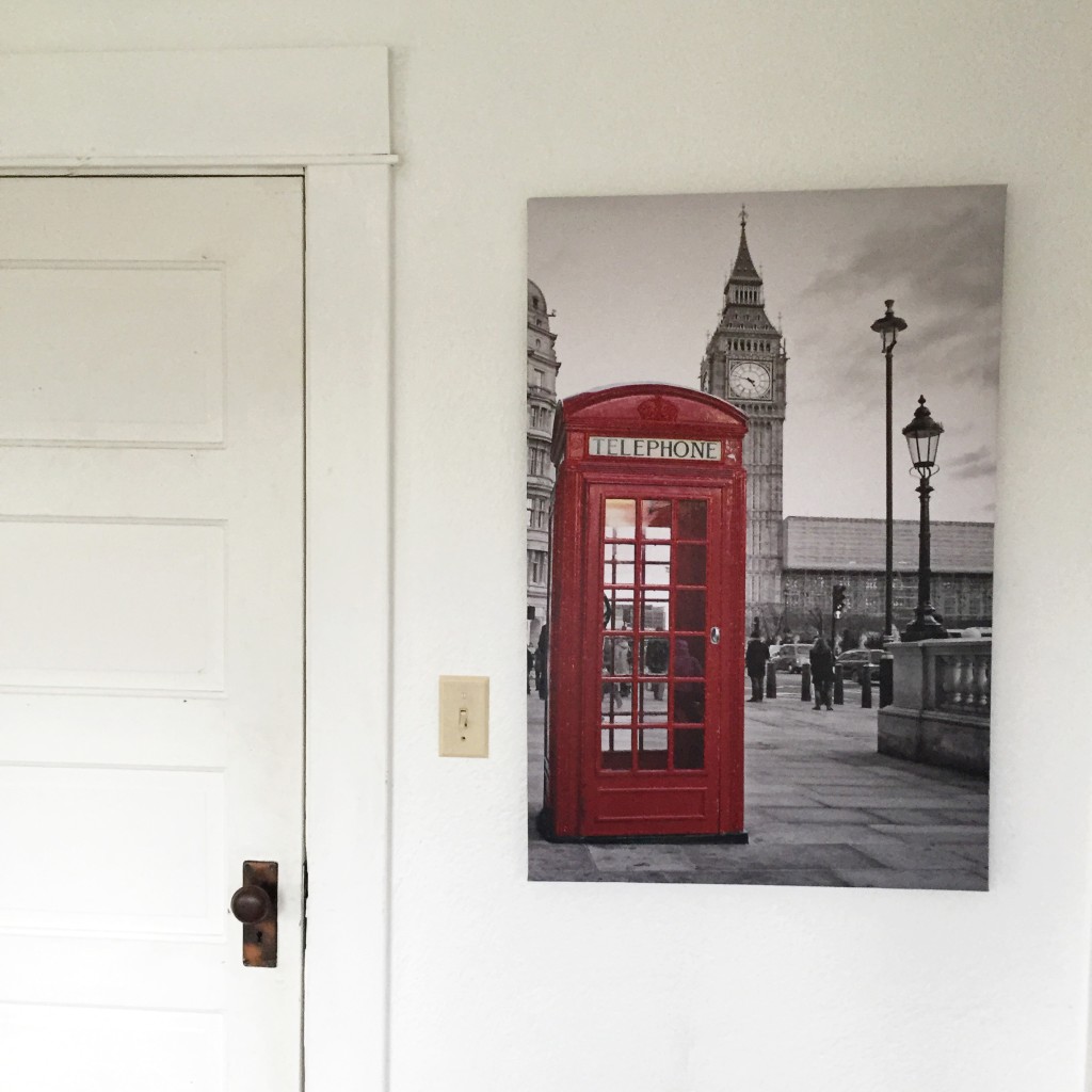 farmhouse white door with a picture hanging next to it of red telephone booth