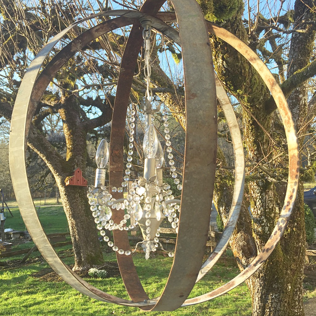 Metal orb with crystal chandelier in the middle