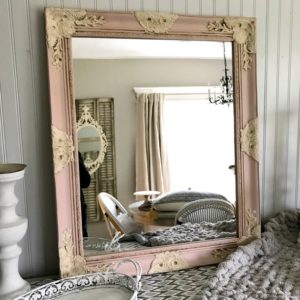 Pink and cream framed mirror with a chunky knit throw blanket