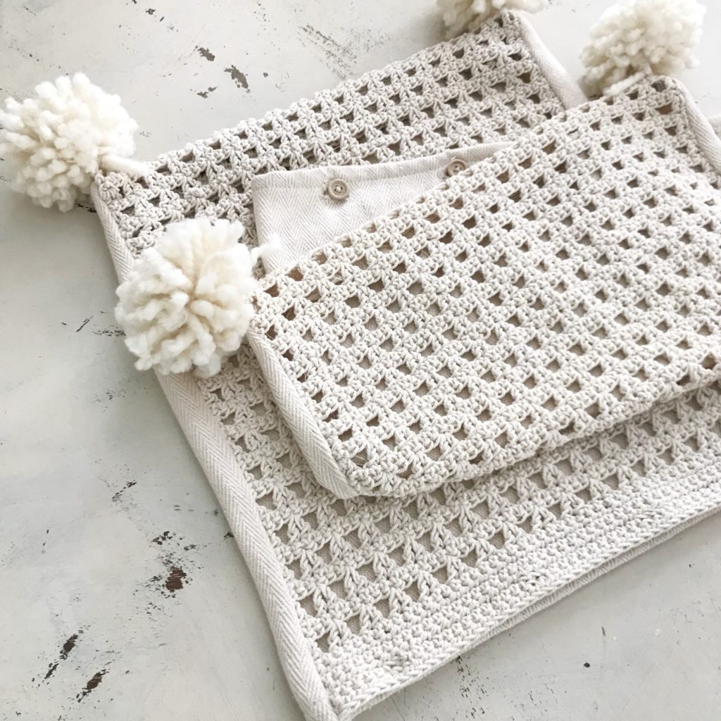 cream knit pillow cases with white pom poms on the corners