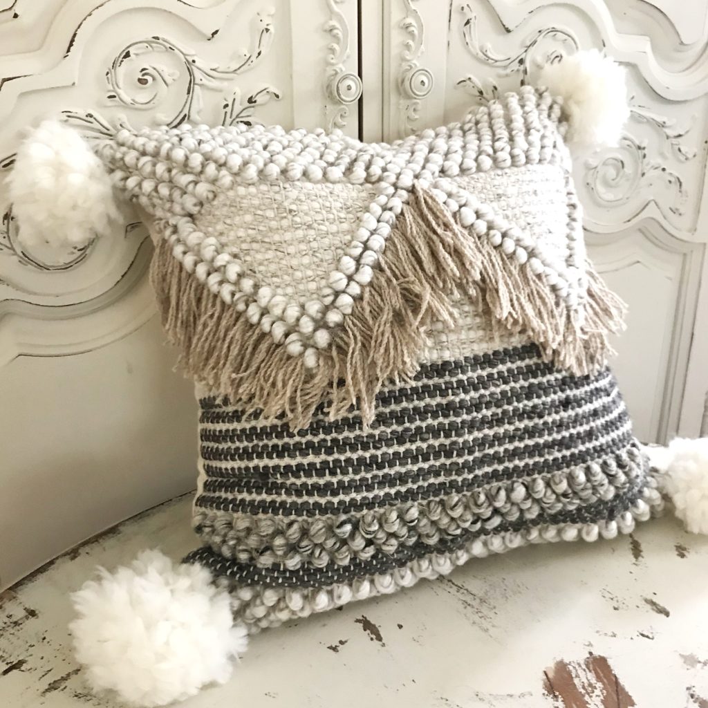 Wool Pom Pom Tutorial for Crafts chunky knit pillow cream and brown with light brown tassels and white pom poms on corners