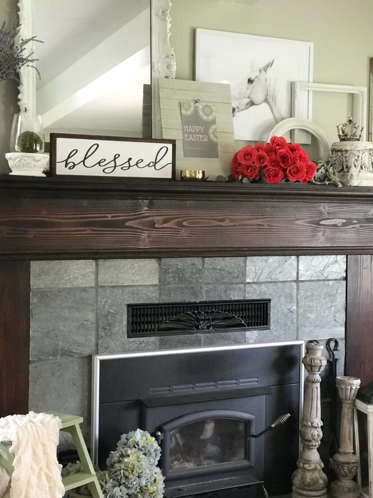 mantel with happy easter sign and blessed scroll sign with bouquet of red roses with large white mirro