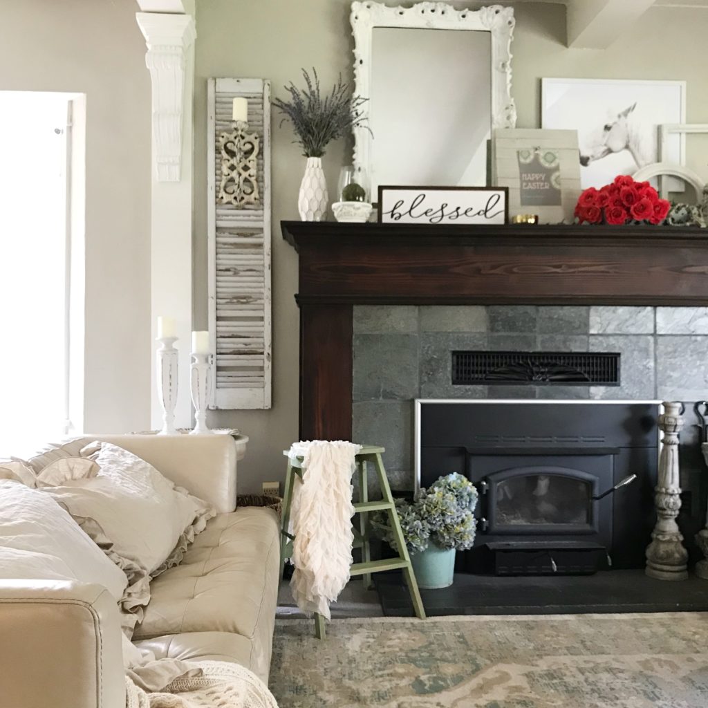 mantel with happy easter sign and blessed scroll sign with bouquet of red roses with large white mirro