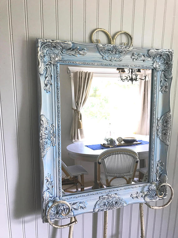 blue and silver mirror on easel