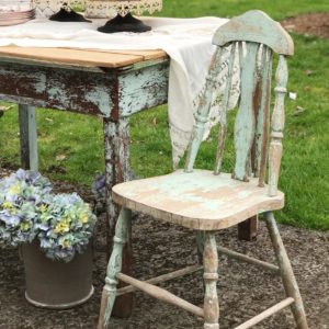Our Farmhouse Decor from HallstromHome blue chippy chair next to antique blue chippy wood table with pot on ground with hyrdrangea bouquet