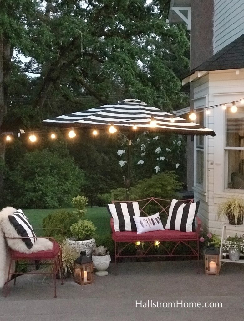 red bench with striped pillows outside on porch