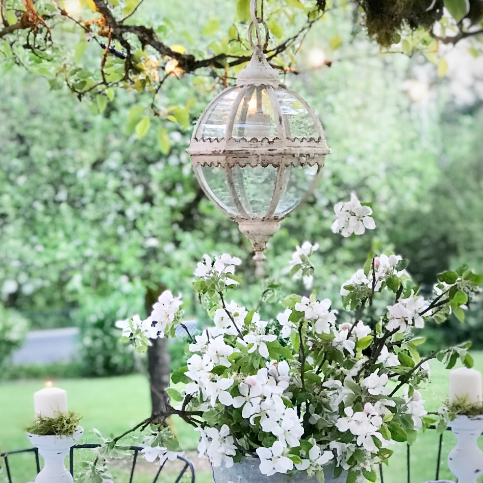 silver bucket with white flowers and round glass chandeleier