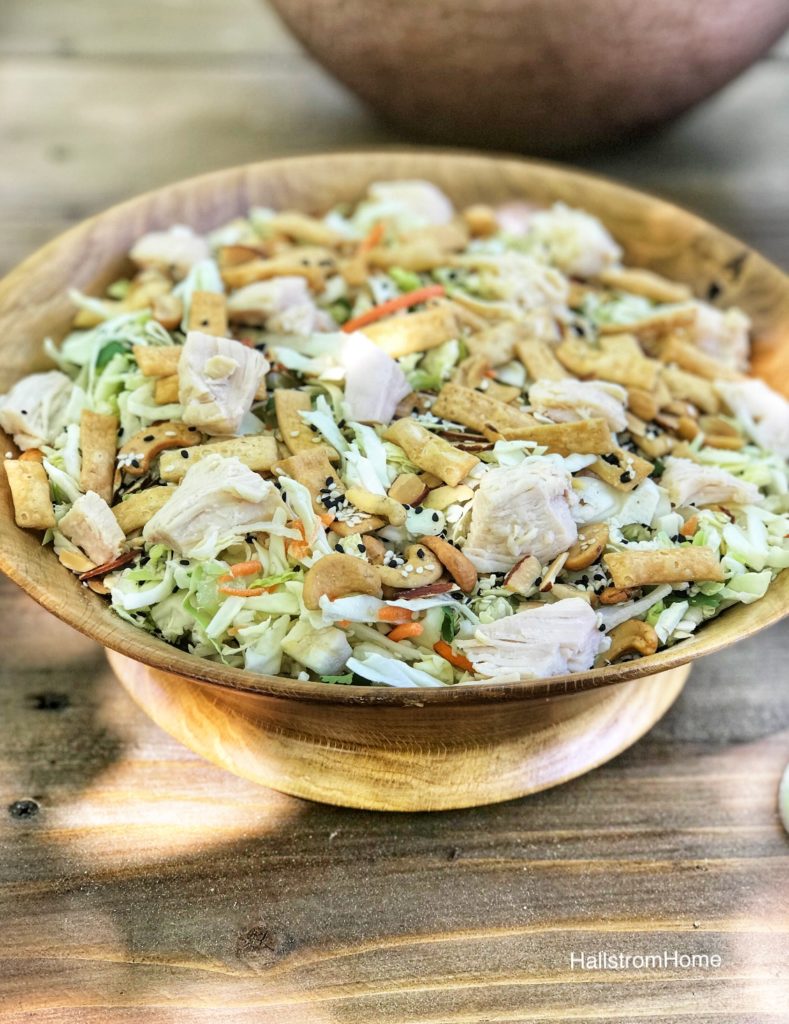 asian chicken salad in wooden bowl