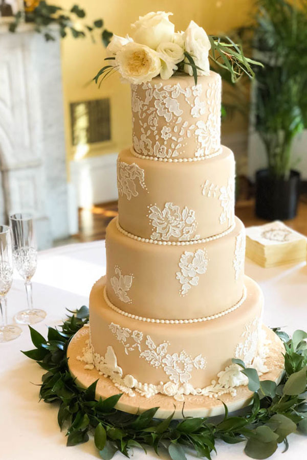 4 tier brown cake with white lace