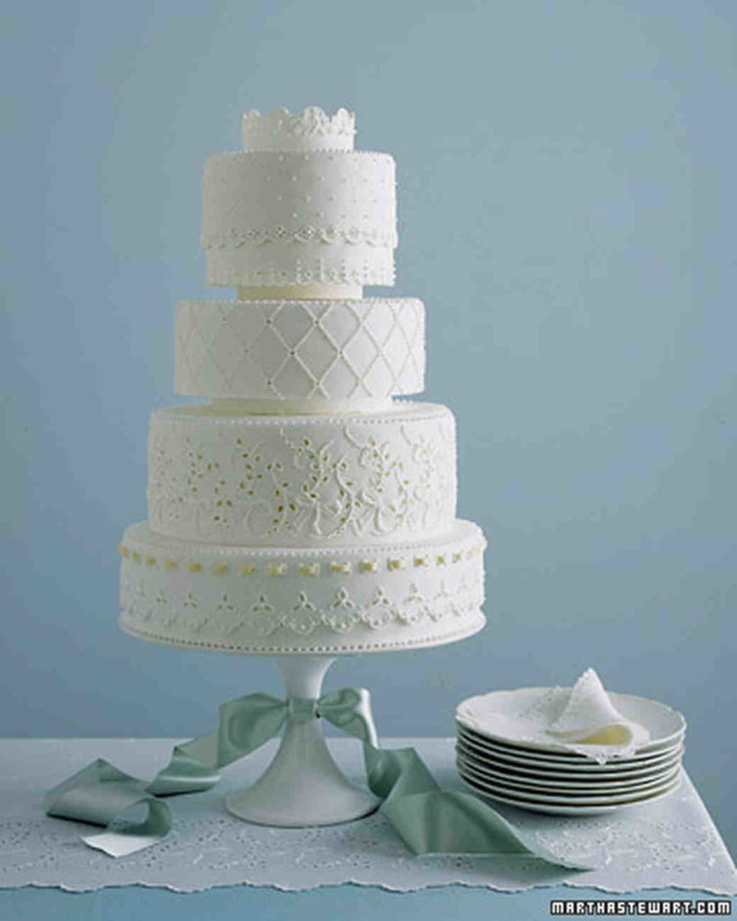 4 tier white cake with lace frosting details