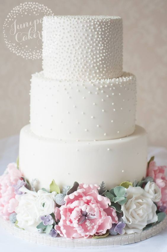 3 tier white cake with pearls and pink and white foundant flowers