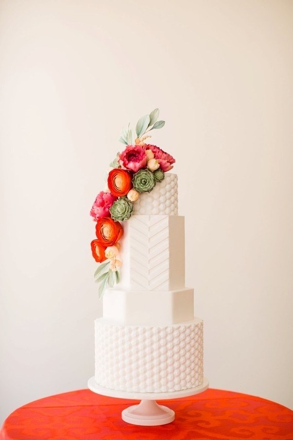 4 tier textured white cake with pink and green flowers