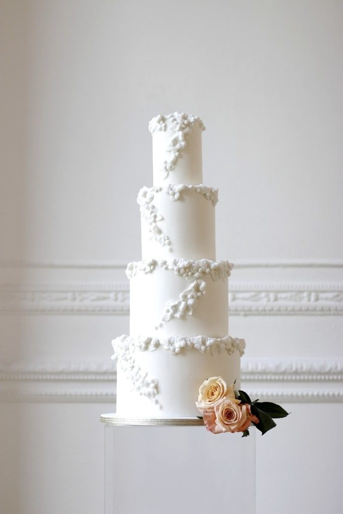 4 tier cake with white flower detailing