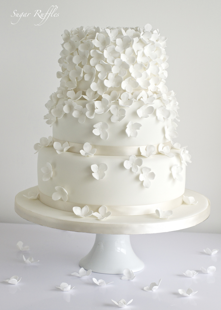 3 tier white cake with white hydrangea flowers