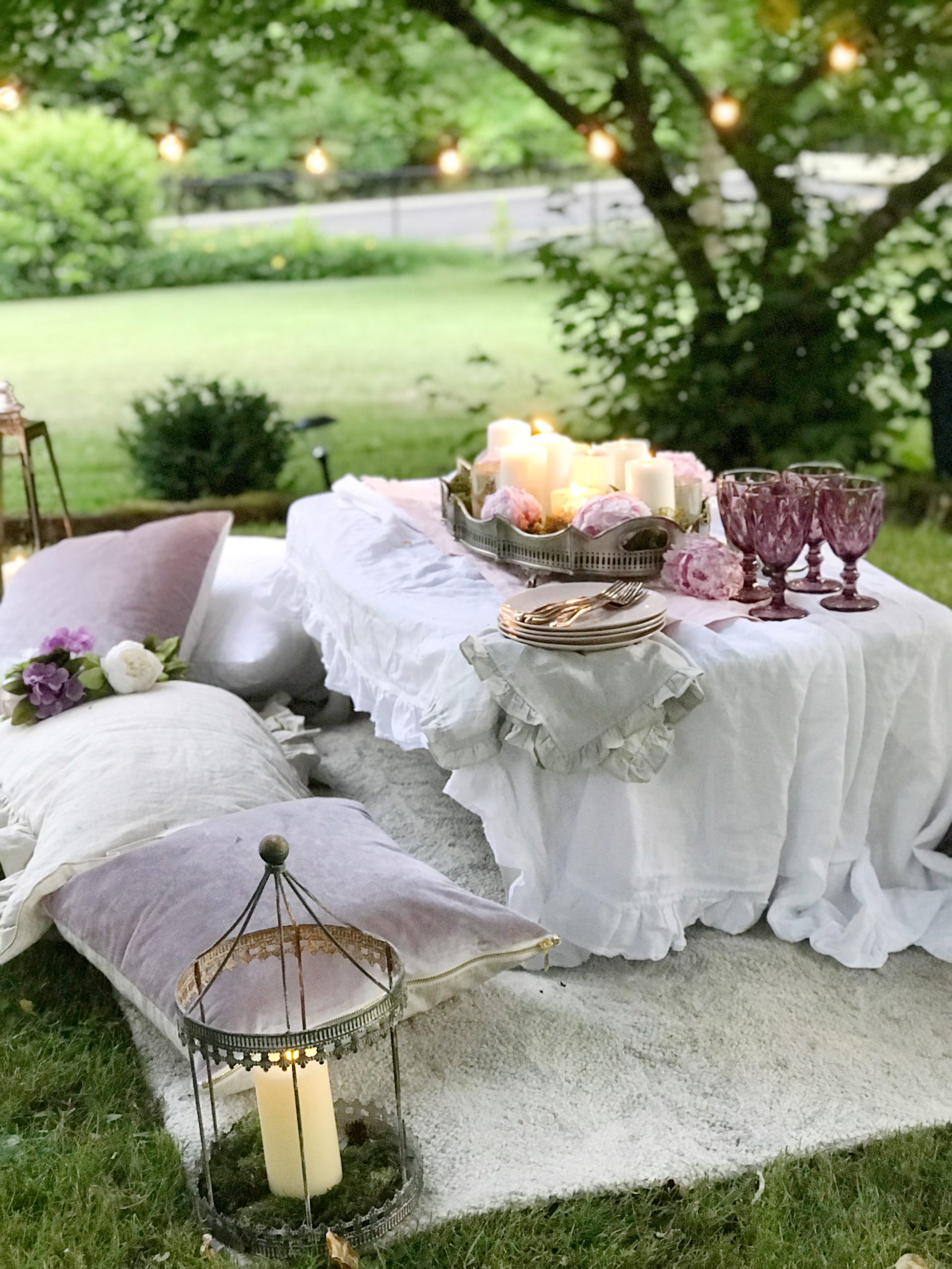 Make Your Outdoor Shabby Chic Wedding Extra Special white table on ground with pillow seating