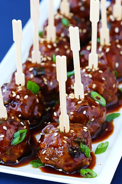 white tray of 12 meatballs with toothpicks in them