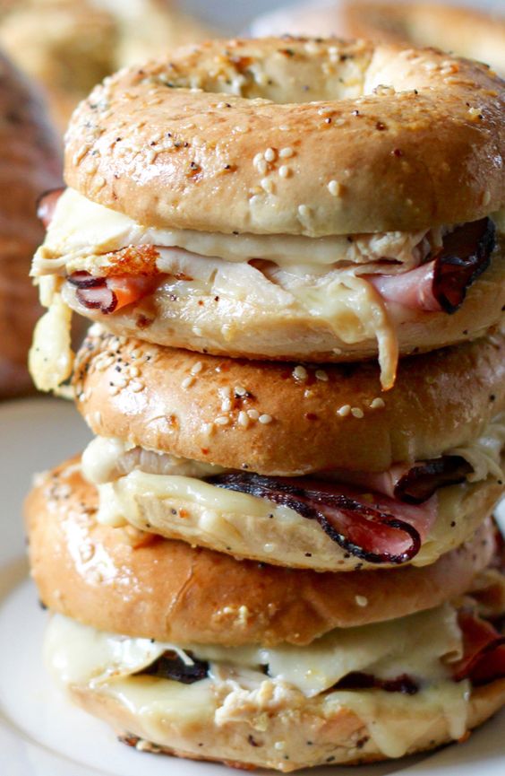 stack of 3 bagel sandwiches with ham and cheese
