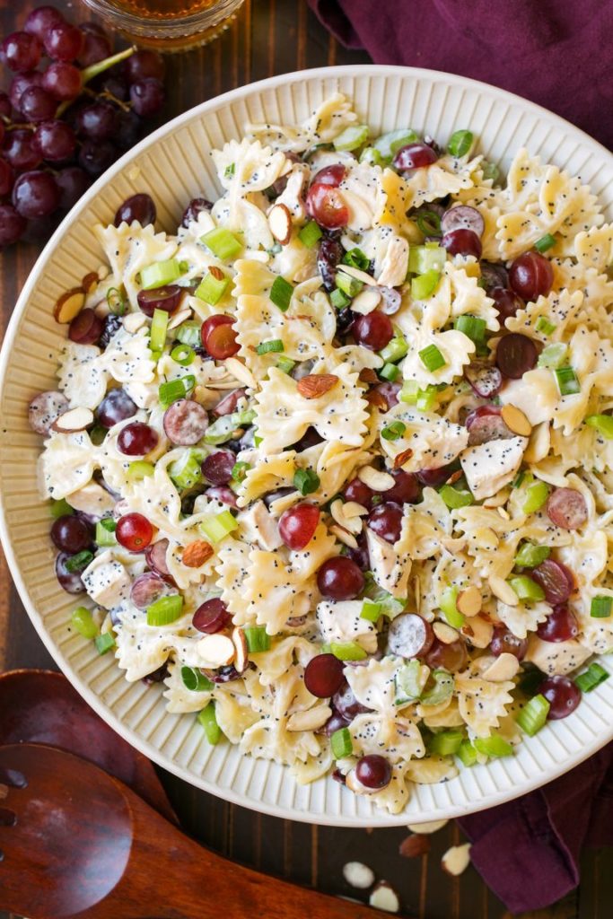 white bowl of pasta salad with grapes 