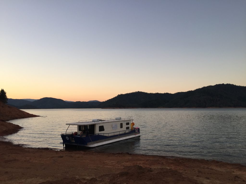 red clay with houseboar on lake