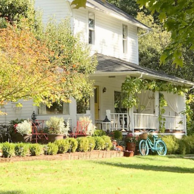 white farmhouse with blue bike