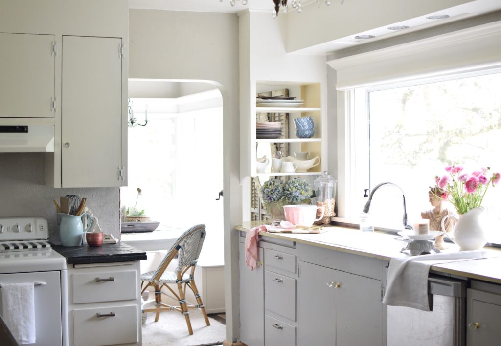 kitchen with gray cabinets and bouuet of blue flowers on counter