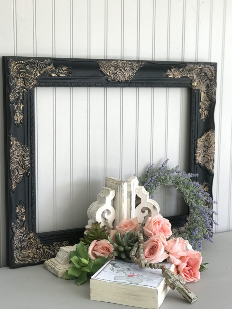 black and gold frame with roses in front