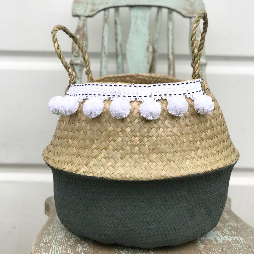 gray woven baskey with white pom poms