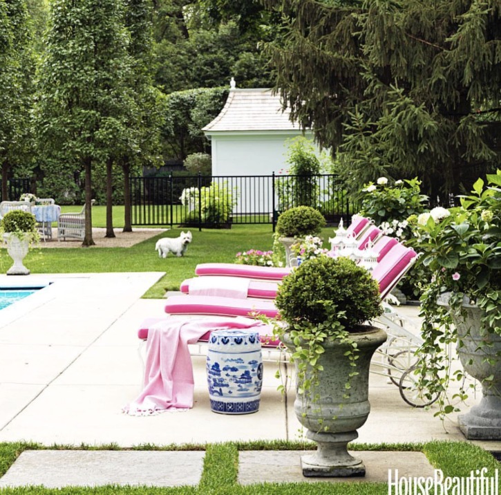 poolside with lounge chairs and boxwood planters