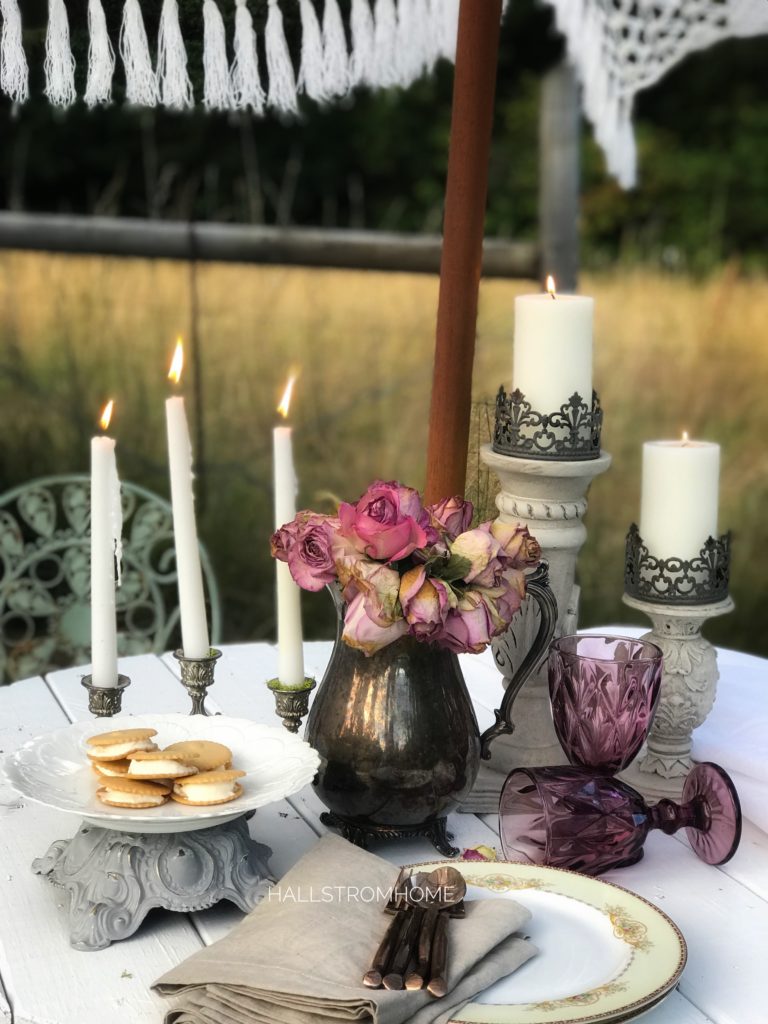 fringe umbrella with candelabra candleholders and silvervase