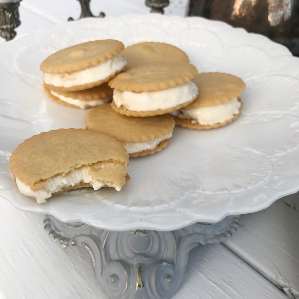 6 ice cream sandwiches one with a bit out of it on a white tray