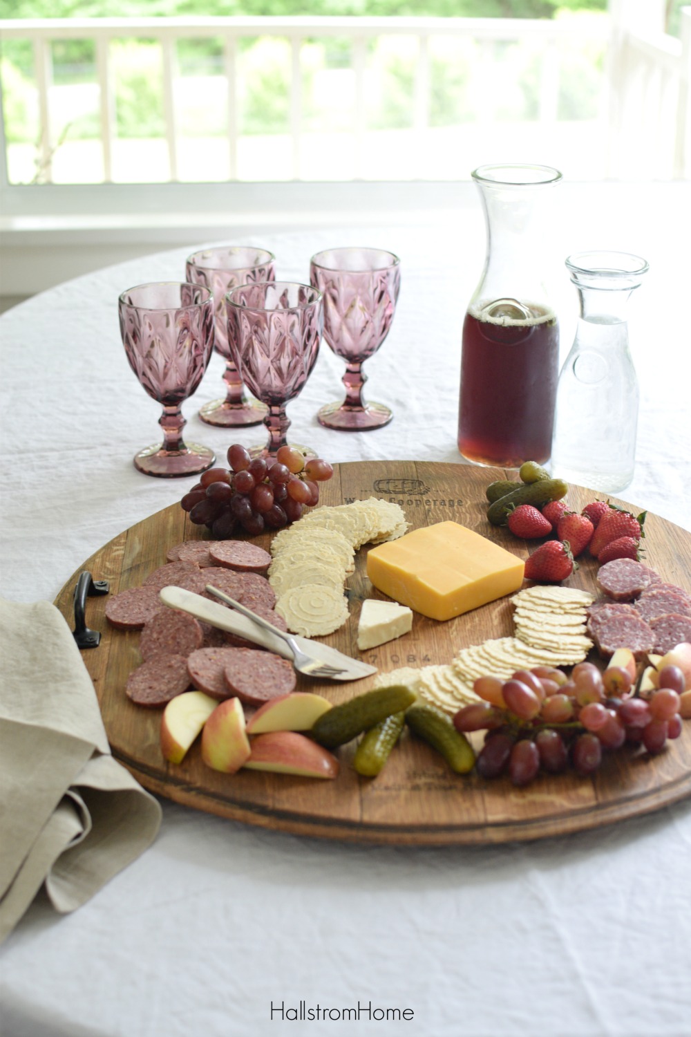 cheese platter with 4 purple cup and pitcher of iced tea