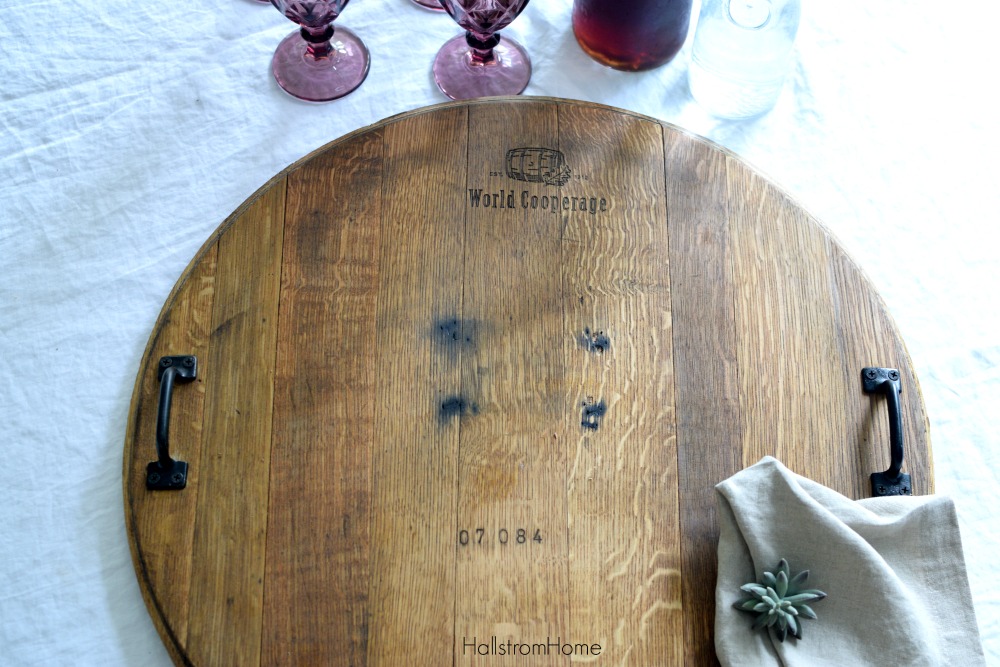 wood cheese board with 4 purple cups and pitcher of iced tea