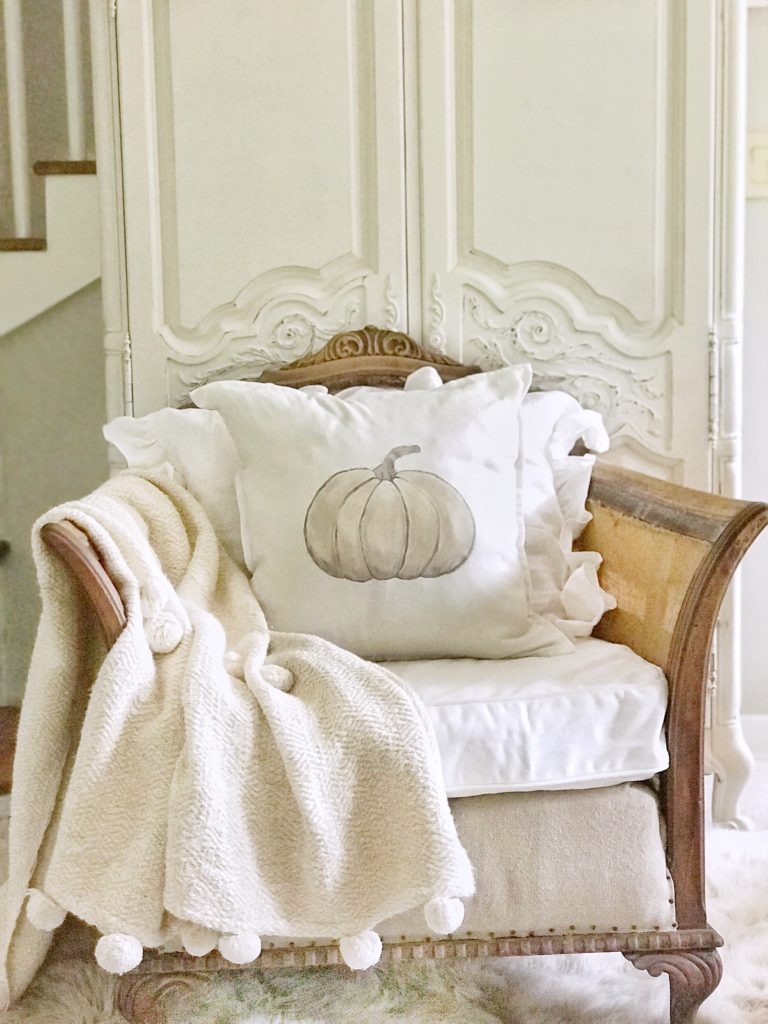 pumpkin pillow on shabby chic chair