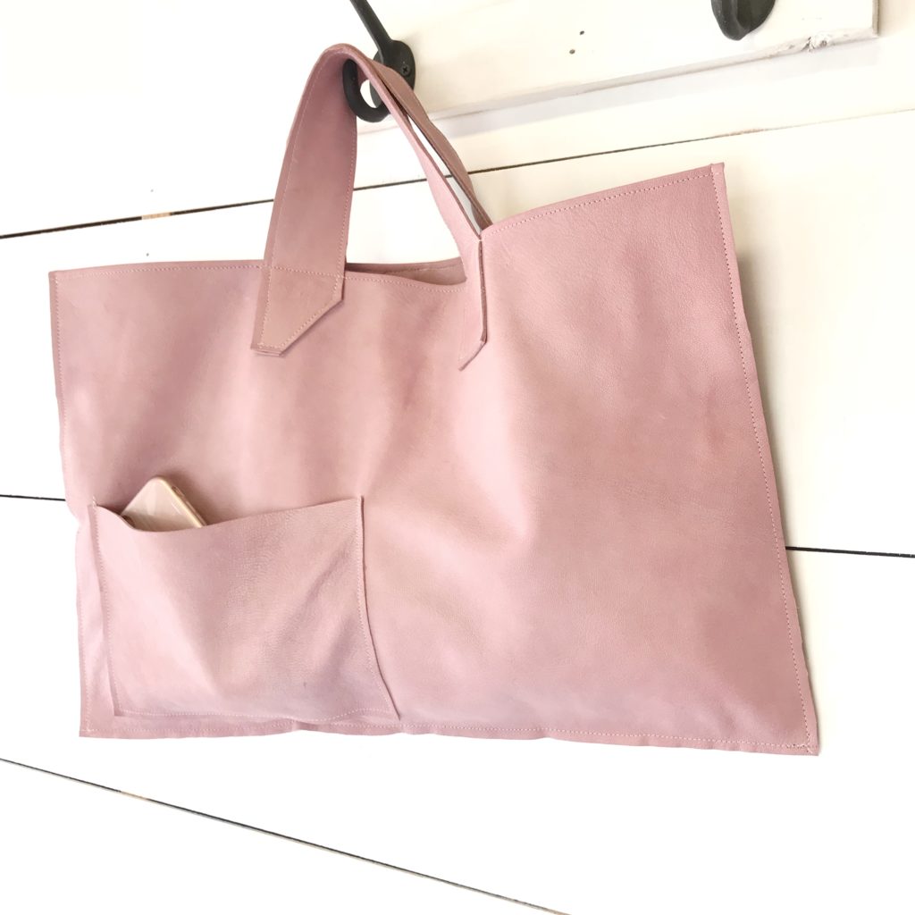 pink leather bag hanging on hook with phone sticking out of pocket |We Have a Fabulous Surprise-Launching a New Product, What Do You Think?