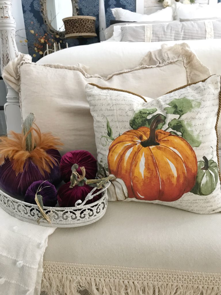 How to Decorate Bedrooms for Easy Fall Decor pumpkin pillow with ruffle linen pillow behind and 4 velvet pumpkins in white tray