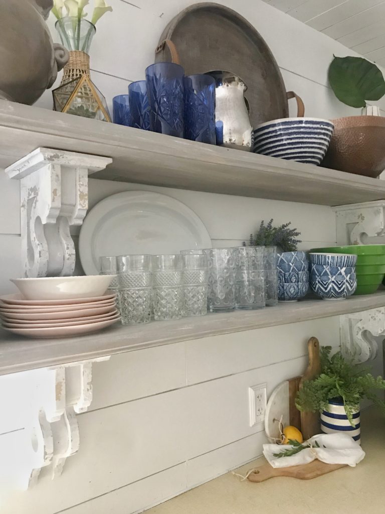 kitchen cabinets with uppers open shelving with plates and bowls