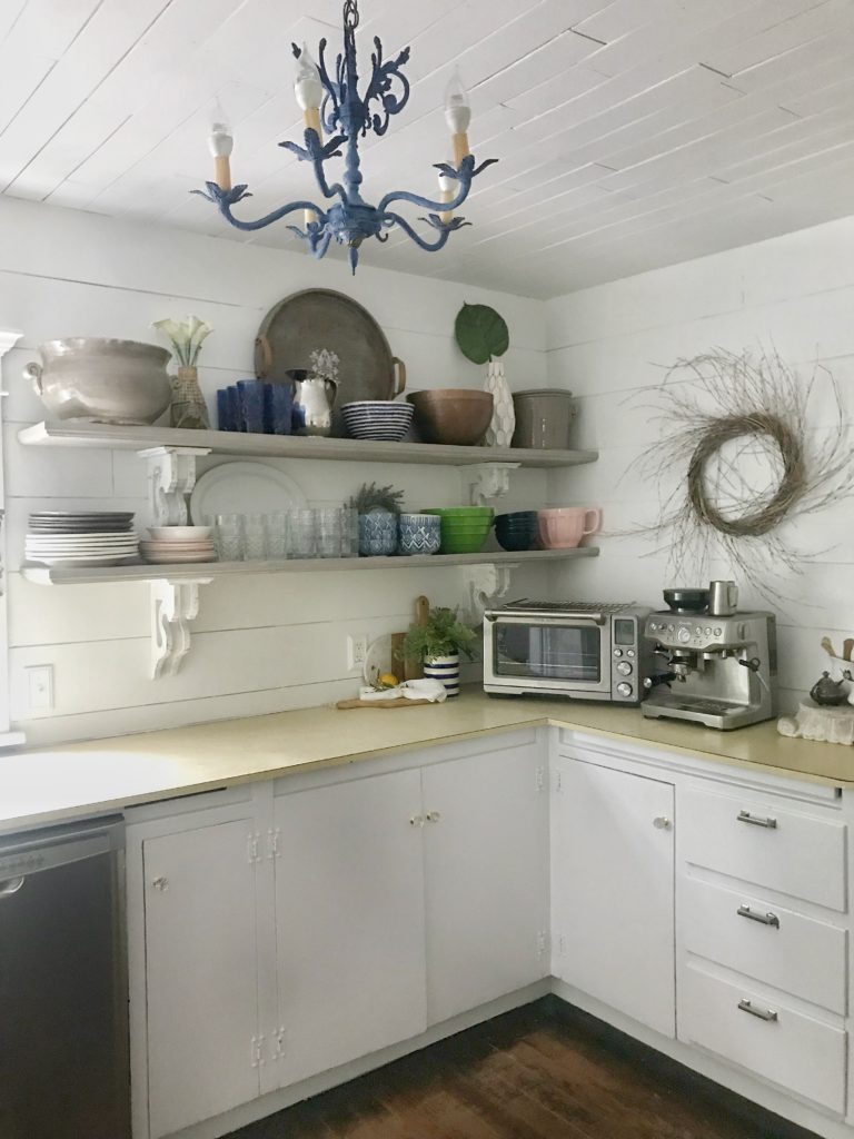 kitchen cabinets with uppers open shelving with plates and bowls