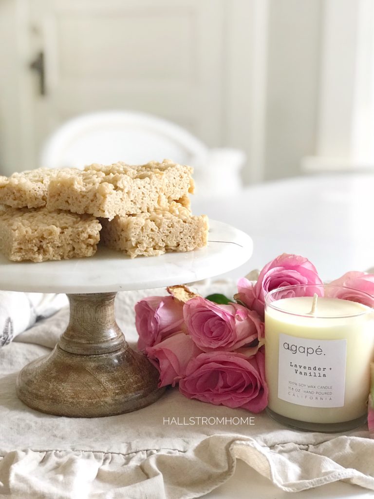 Cake stand with 7 rice krispies with bouquet of pink roses with white candle