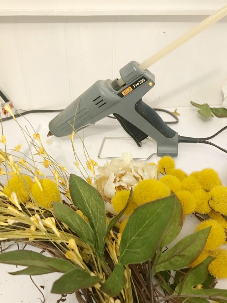How to Make a Fall Wreath for Your Home yellow and green florals with hot glue gun