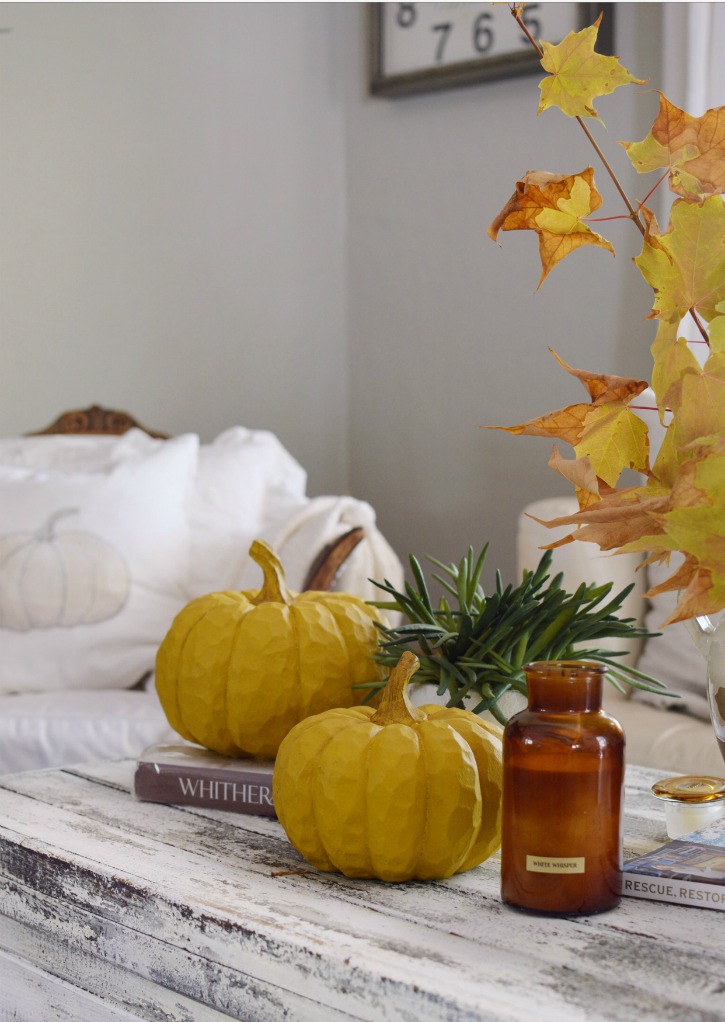 2 pumpkins and candle with fall leaves on white farmhouse Beautiful Fall Farmhouse Home Tour with Easy Scone Recipe 