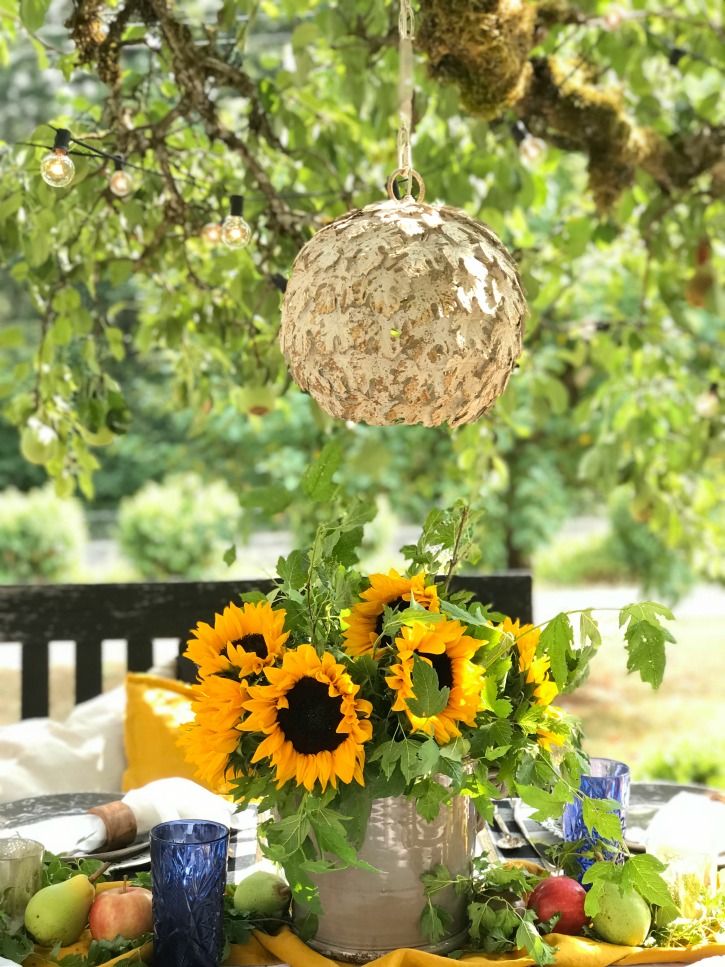 How to Decorate Your Fall Table in the Garden with bouquet of sunflowers and chandelier