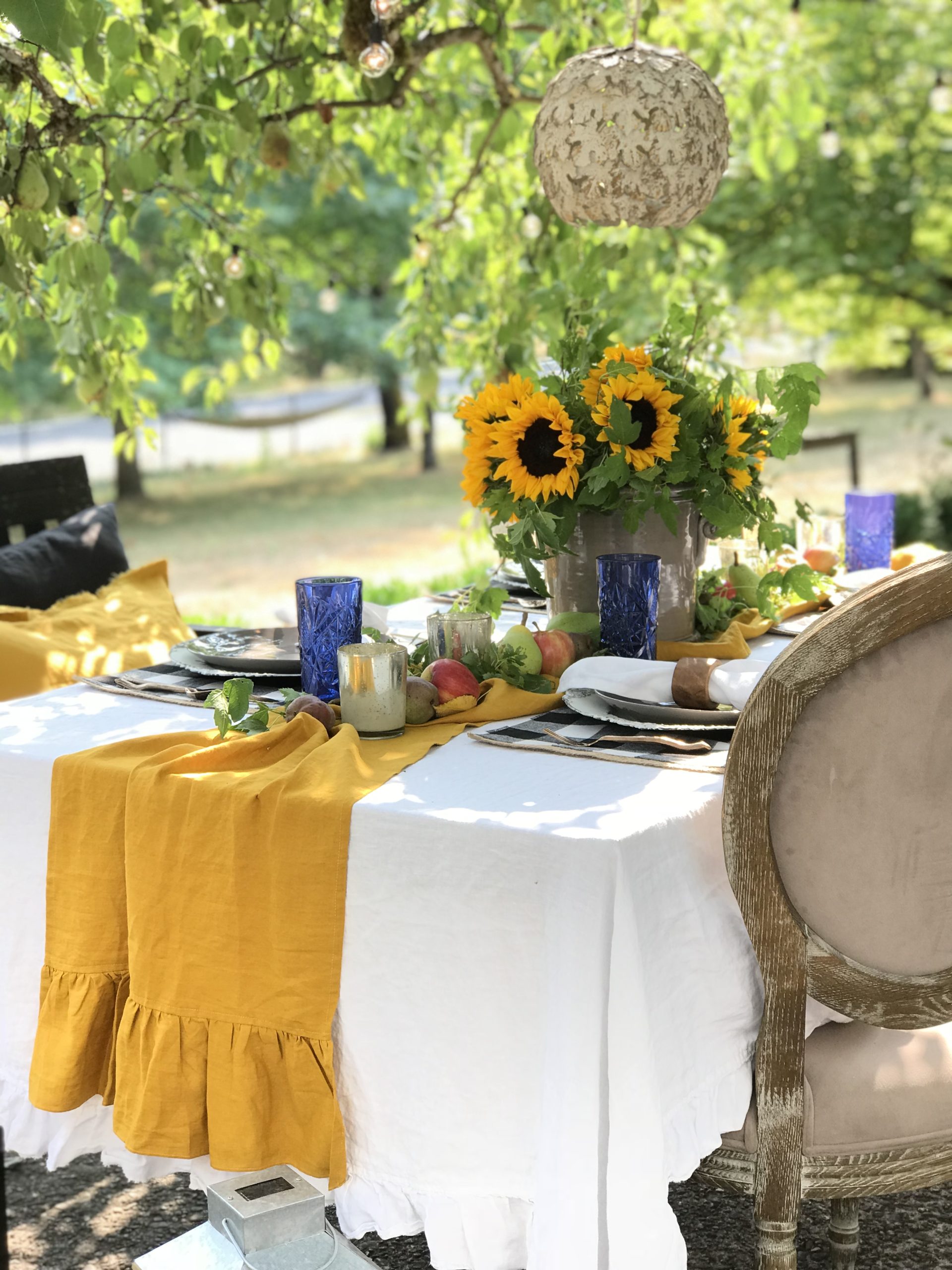 How to Decorate Your Fall Table in the Garden with yellow table runner and sunflower centerpiece