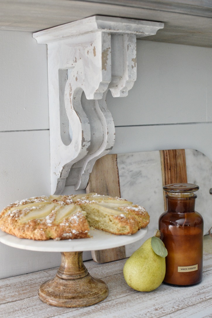pear scones on cake stand with candle and pear