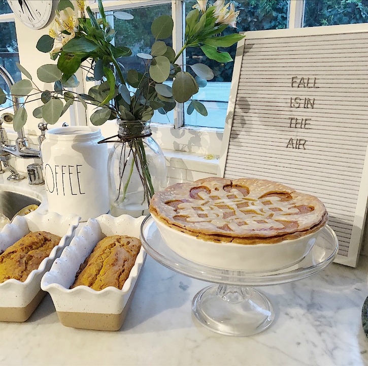 stenciled pumpkin pie and cake stand with 2 loaves of bread