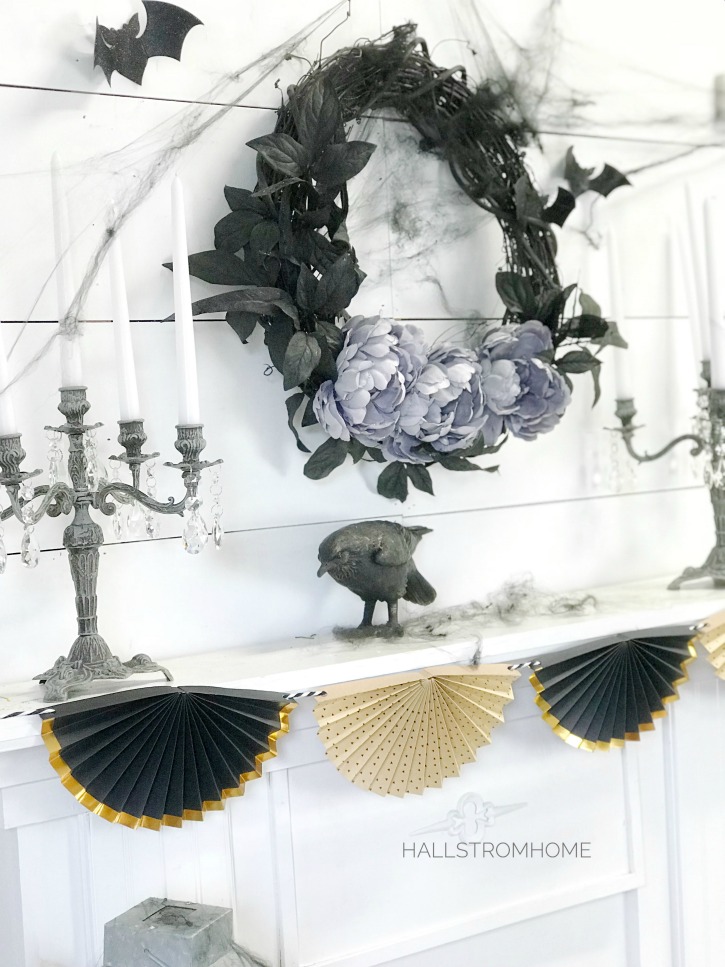 #1 Halloween Wreath that's Easy Elegant and Beautiful black wreath above mantel with crow and 2 candelabras with fan banner